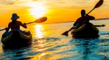 A couple kayaking during sunset